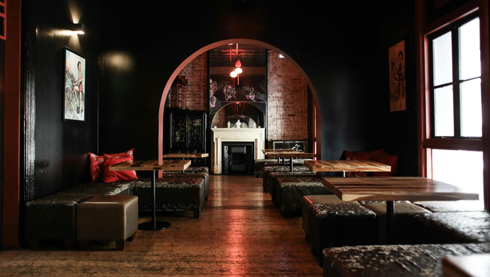 Explore the stylish, dimly-lit lounge bar with elegant seating and arched architecture for ultimate comfort.